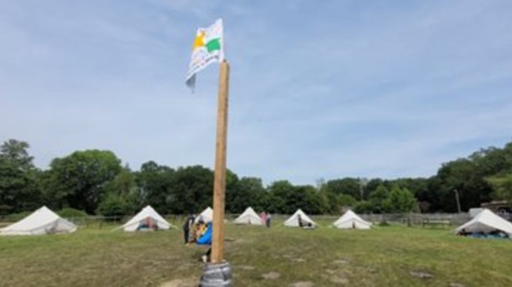 Zeltplatz mit Bannermast in der Mitte